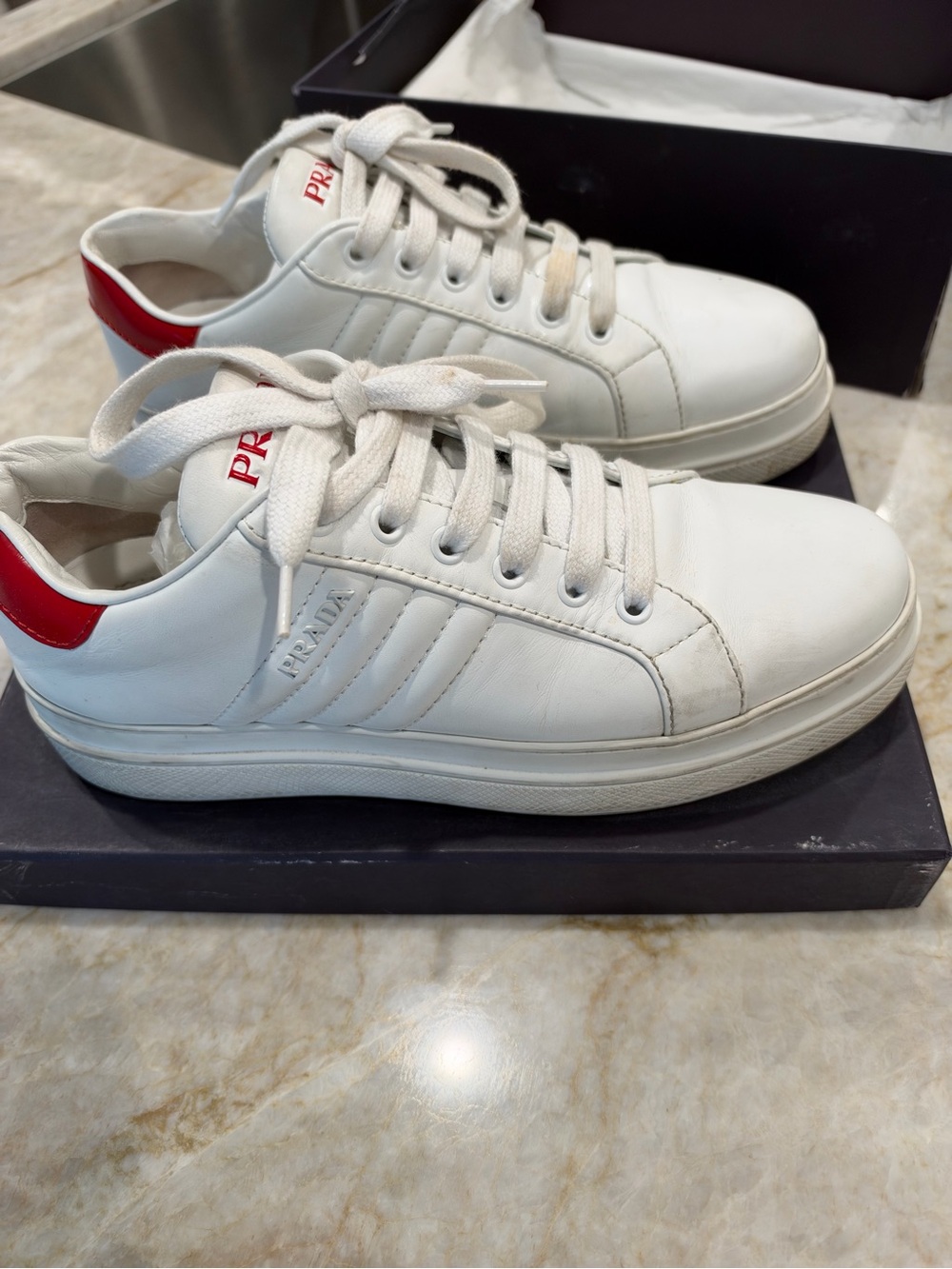Prada White Leather Low-Top Sneakers with Red Heel Accent